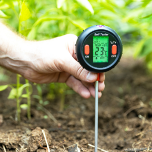 Lawn services worker runs a soil ph test on a yard.