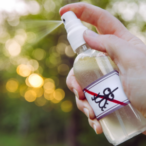 A person sprays mosquito repellant 